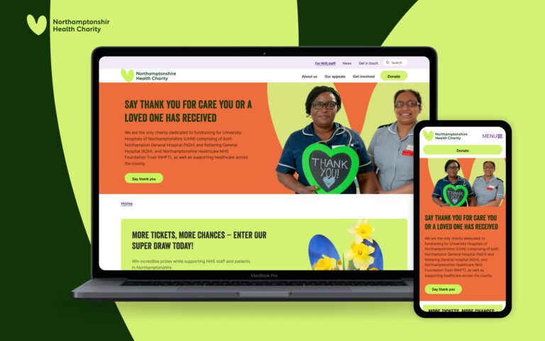 A laptop and smartphone display the Northamptonshire Health Charity website, featuring two smiling healthcare workers holding a green heart-shaped sign that says Thank You! on a bright, colorful background.